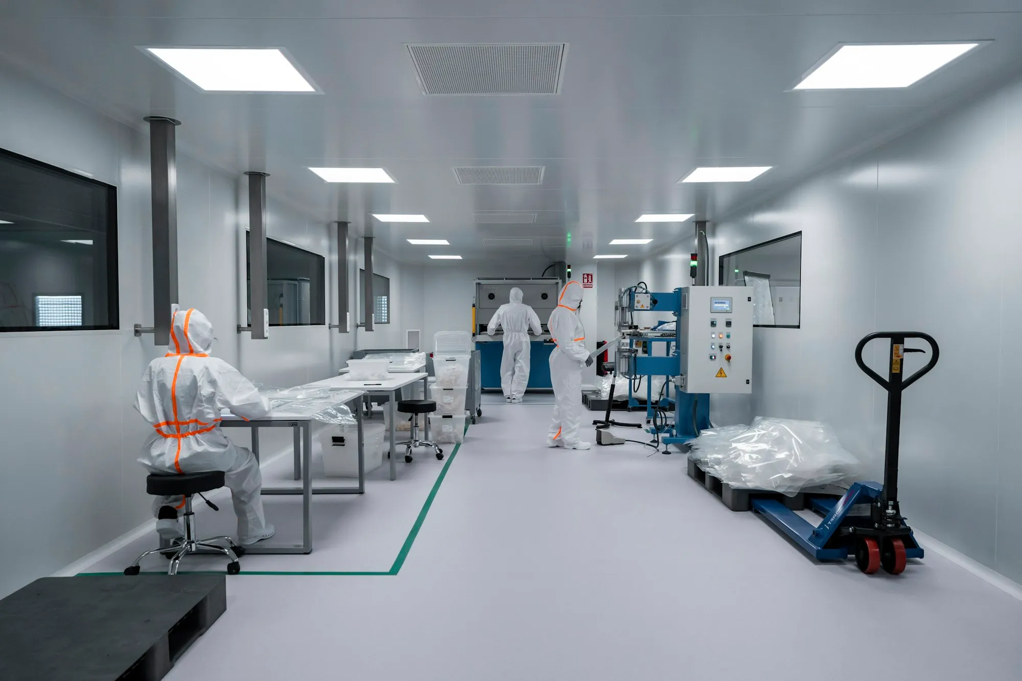 Team members working in a controlled pharmaceutical production environment