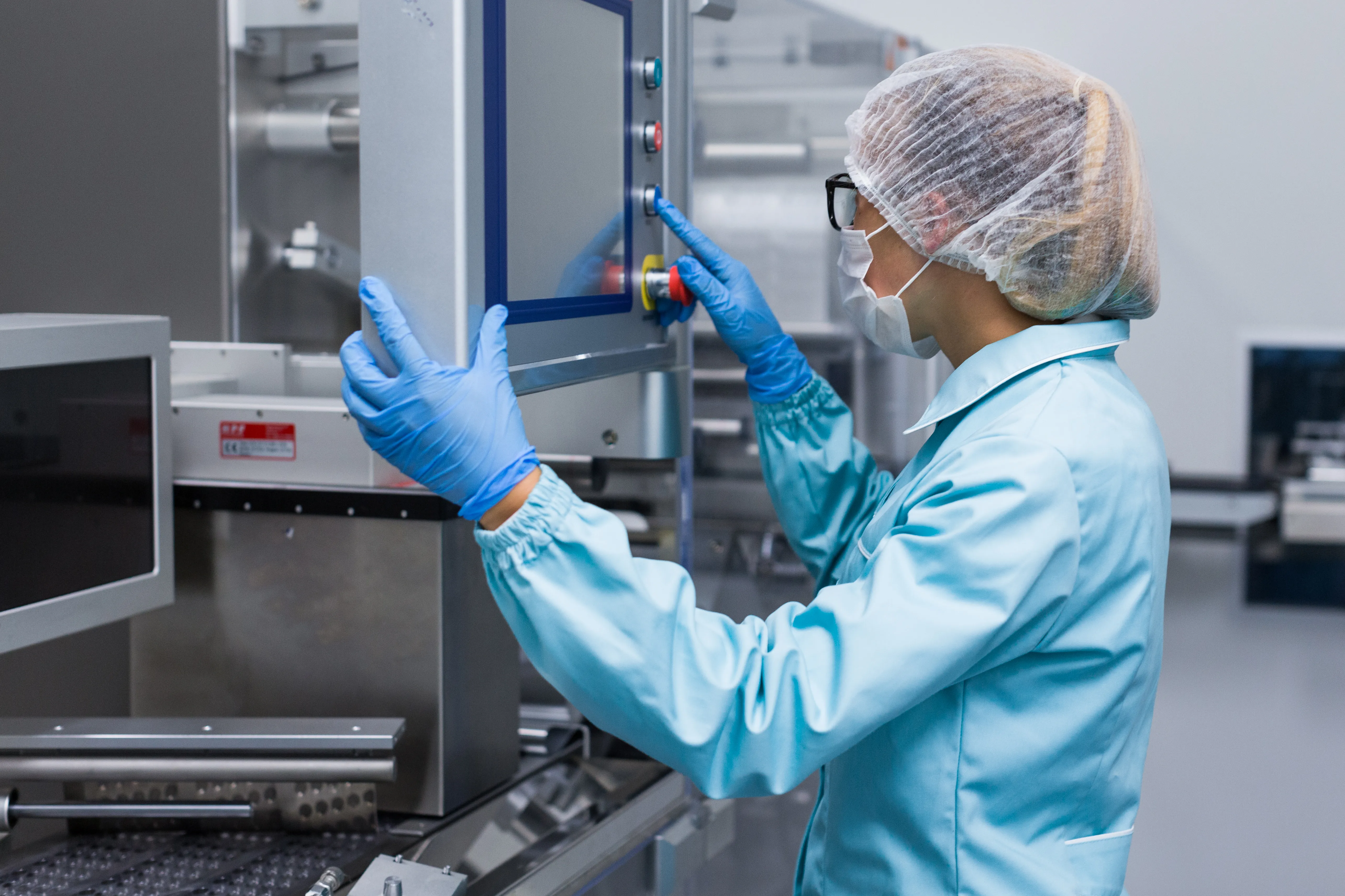 Pharmaceutical operator working with sterile equipment in a controlled environment
